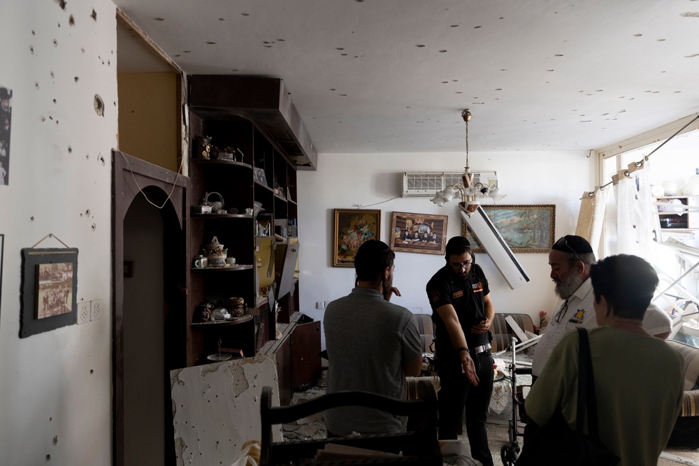Residents inspect damage on a residential building hit by a rocket fired from Lebanon in Kiryat Yam near Haifa, Israel (Getty Images)