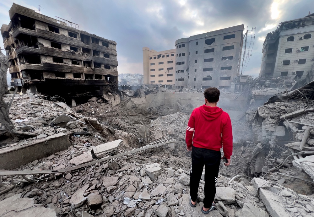 A man looks at destroyed buildings hit by Israeli airstrikes in Dahiyeh, Beirut, Lebanon (AP)