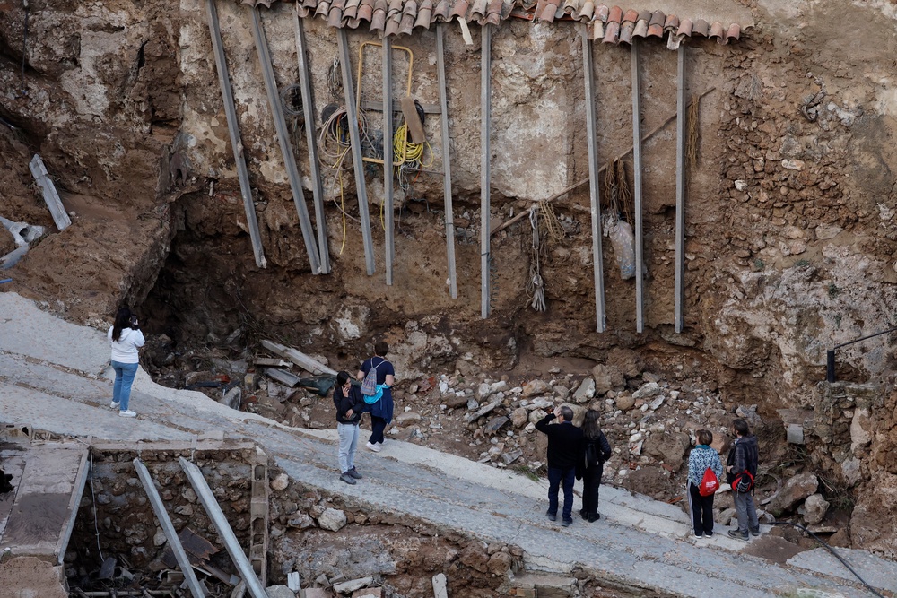 Residents look at damaged road and houses following floods in Letur, southwest of Valencia, eastern Spain (AFP via Getty Images)