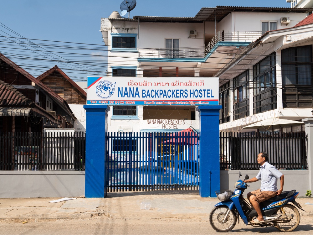 A motorcyclist passes the Nana Backpackers Hostel in Vang Vieng on November 24, 2024 (AFP/Getty)