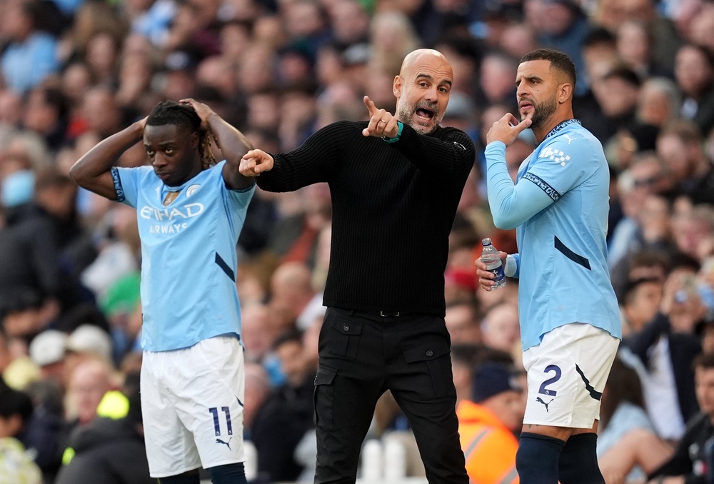 Manchester City manager Pep Guardiola (middle) fell out with Kyle Walker (PA Wire)
