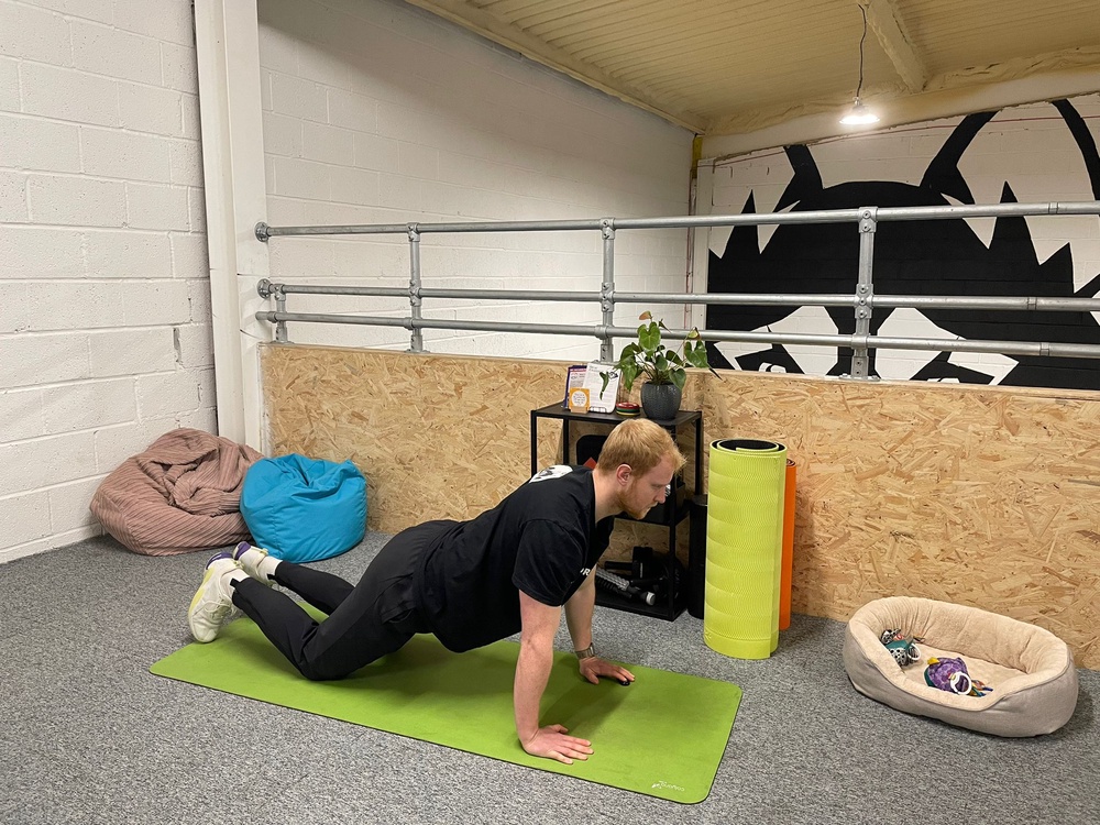 Harry Bullmore demonstrating a kneeling press-up (Harry Bullmore / The Independent)