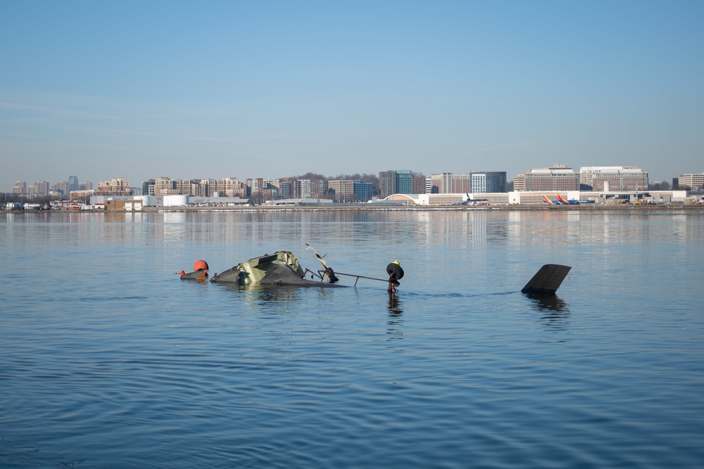 Image from: DC plane crash latest: First parts of plane wreckage are lifted from Potomac after families visit disaster site