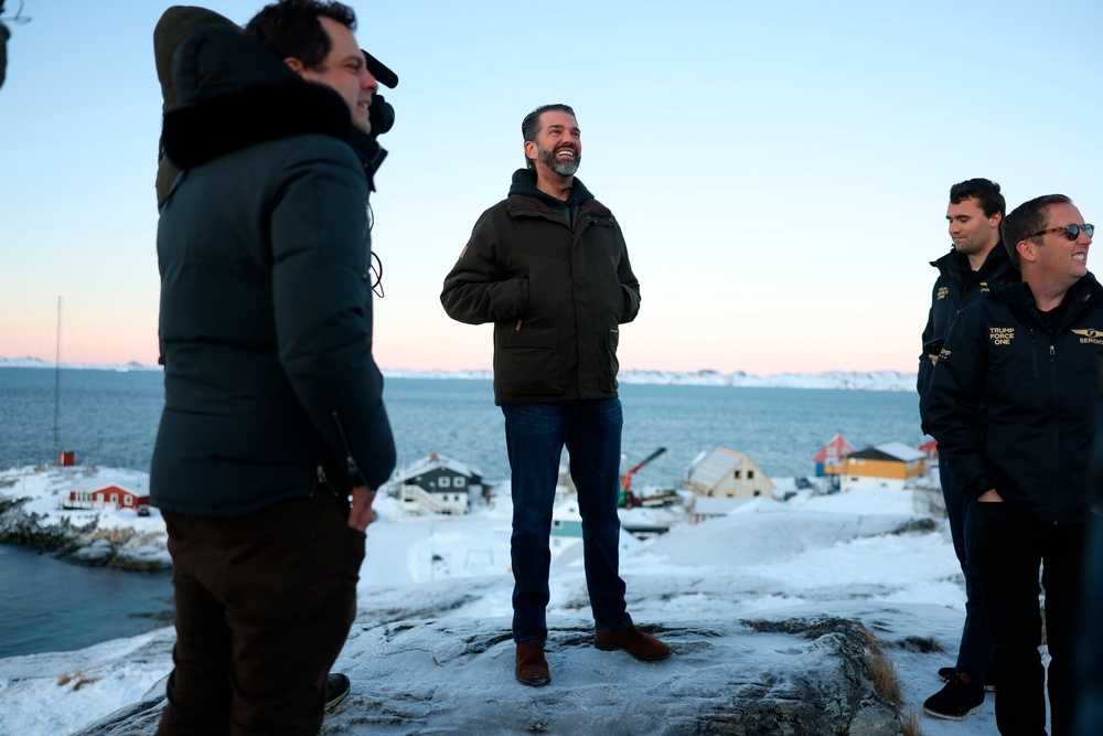 Donald Trump Jr., center, smiles after arriving in Nuuk, Greenland, Tuesday, Jan. 7, 2025 (AP)