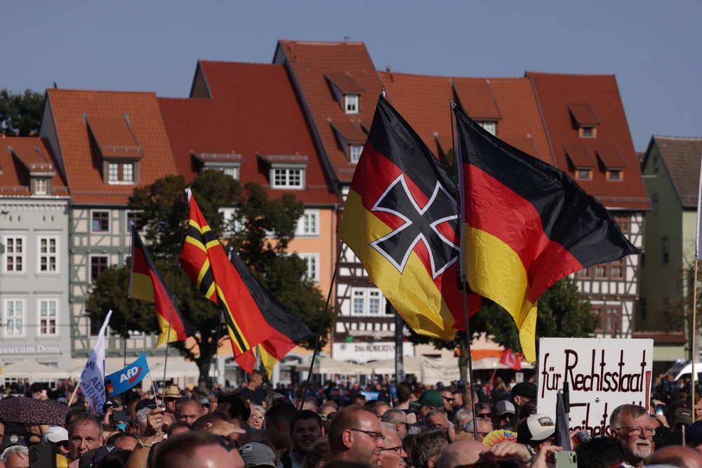 AfD supporters waved German flags, including one adorned with an Iron Cross, at the final AfD campaign rally ahead of Thuringia state elections in August 2024 (Sean Gallup/Getty Images)