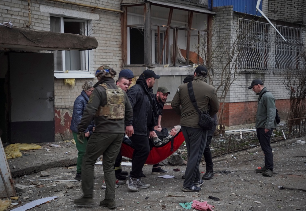 Rescuers and volunteers evacuate a wounded person from an apartment building damaged during a Russian missile strike, amid Russia's attack on Ukraine, in Sumy on Monday (REUTERS)