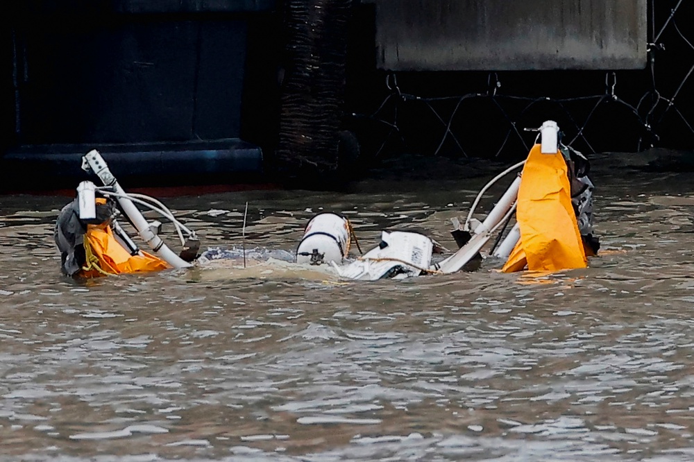 Four people were retrieved from the river, two of whom were still alive but later died of their injuries (REUTERS)