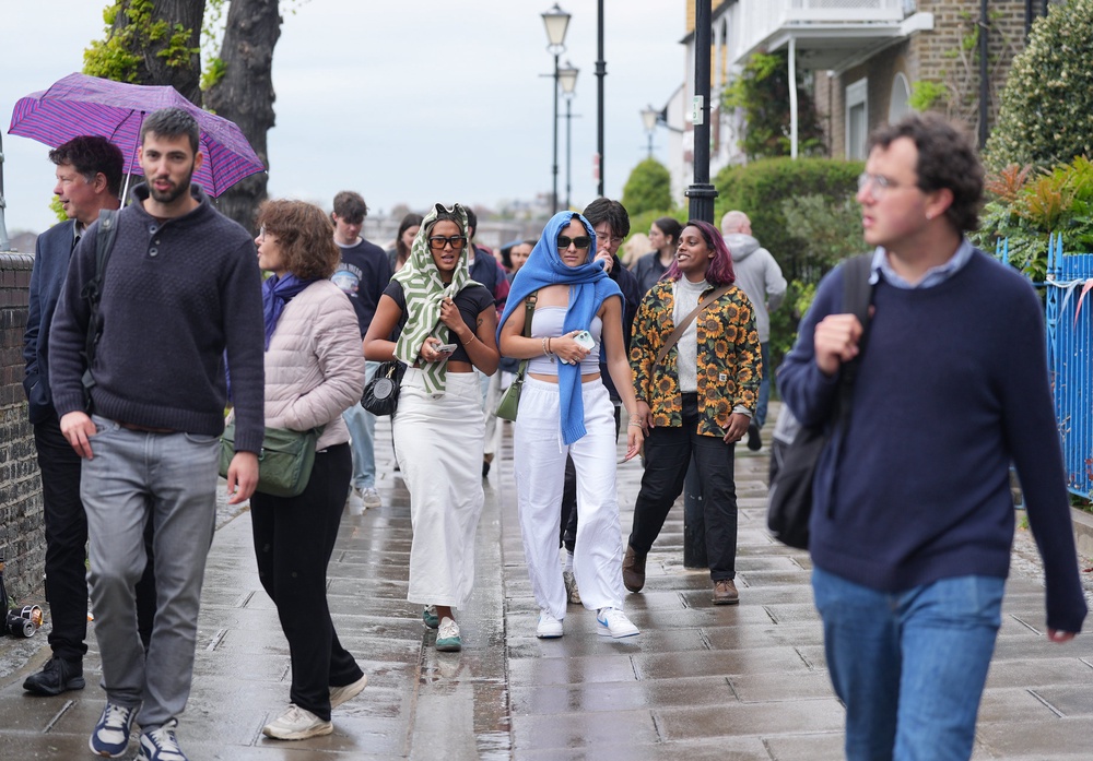 People walk in a rain shower in London’s Hammersmith (Yui Mok/PA Wire)