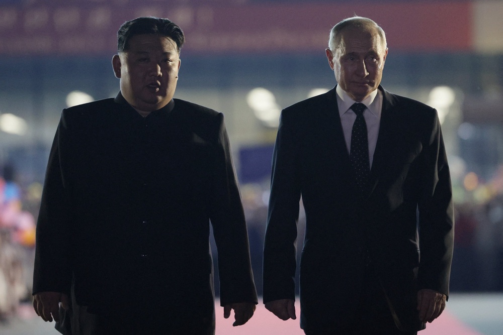 Russian president Vladimir Putin and North Korean leader Kim Jong Un walk during a farewell ceremony in Pyongyang (AFP via Getty Images)