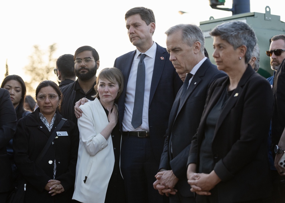 Canadian Prime Minister Mark Carney, second from right, British Columbia Premier David Eby, second from left and his wife Cailey Lynch attend the candlelit vigil on Sunday evening (Getty Images)