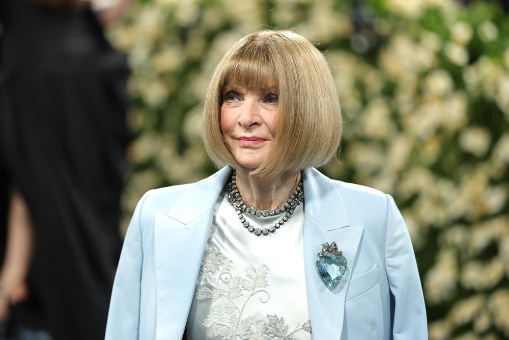 Wintour, a co-chair for the annual event, embellished her look with a strawberry-shaped glass brooch and a layered diamond necklace (Getty Images)