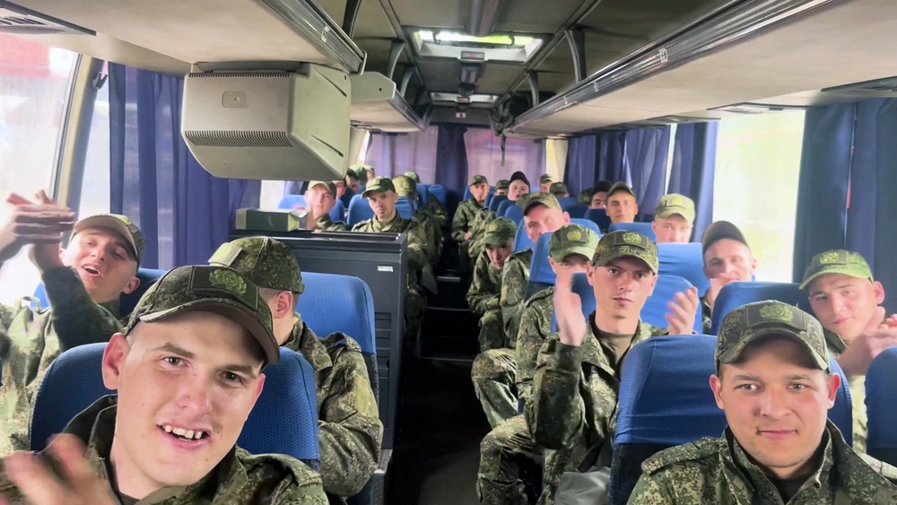 In this video grab taken from a handout footage released by the Russian Defence Ministry on 6 May, 2025, freed Russian prisoners of war (POWs) react sitting in a bus following a swap at an undisclosed location (Russian Defence Ministry)