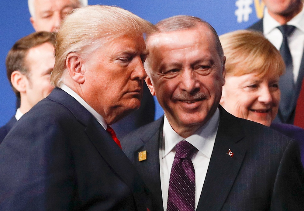 US president Donald Trump and Turkey's president Recep Tayyip Erdogan leave the stage after the family photo to head to the plenary session at the Nato summit at the Grove hotel in Watford (POOL/AFP via Getty Images)