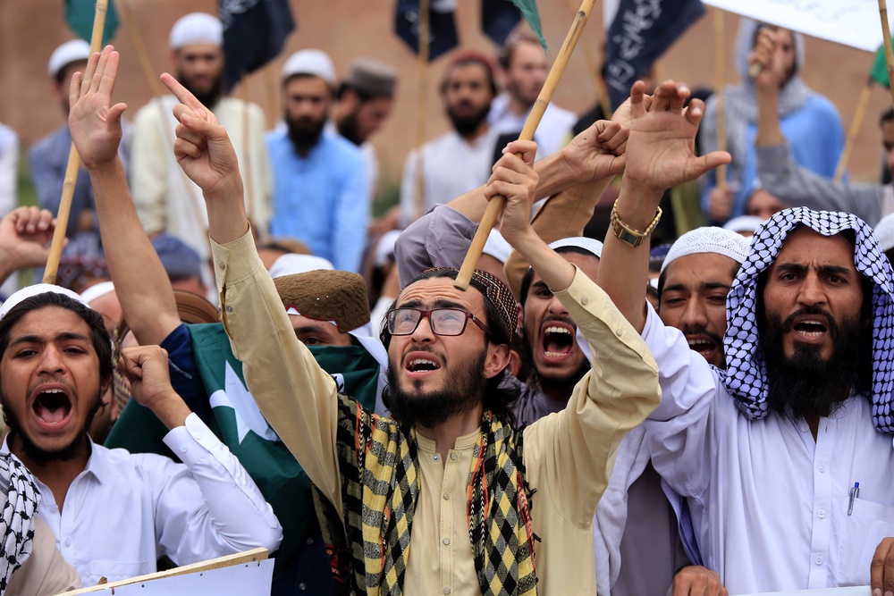 People hold national flags and placards, shouting anti-India slogans during a protest in front of the paramilitary FC headquarters, after India launched missile strikes in Pakistan, in Peshawar, Pakistan, 10 May 2025 (EPA)