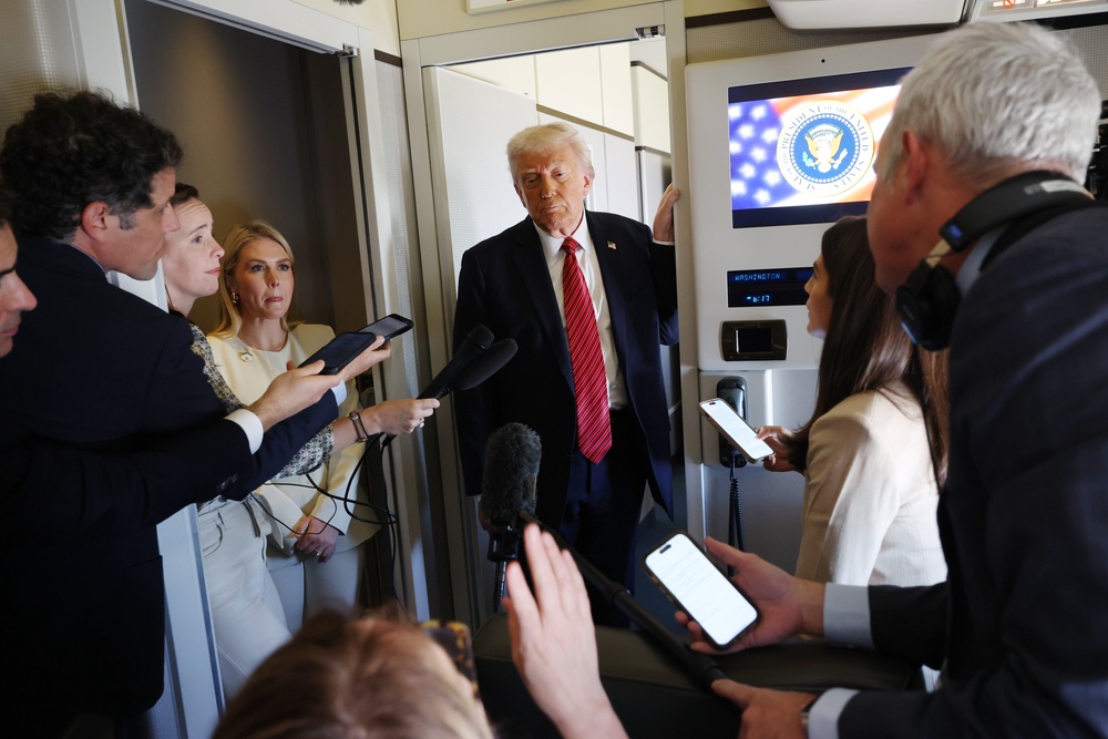 Trump speaking to reporters during the flight to Qatar earlier today (Getty Images)