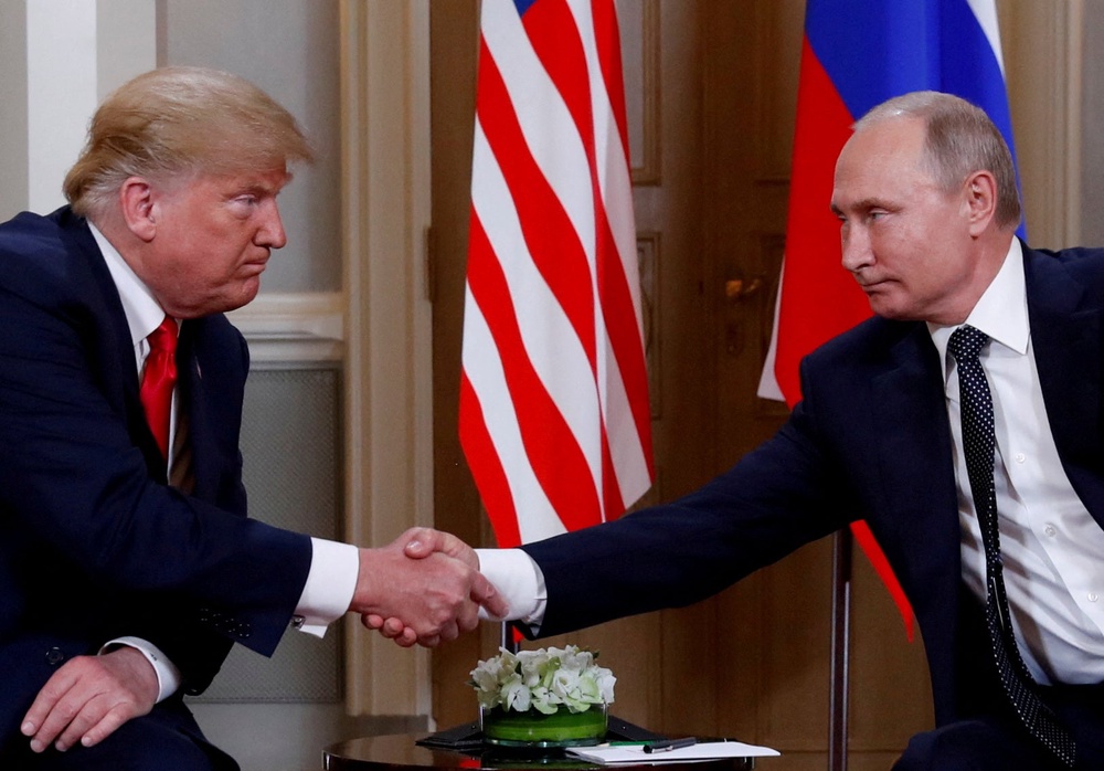 US president Donald Trump and Russia's president Vladimir Putin shake hands as they meet in Helsinki (Reuters)