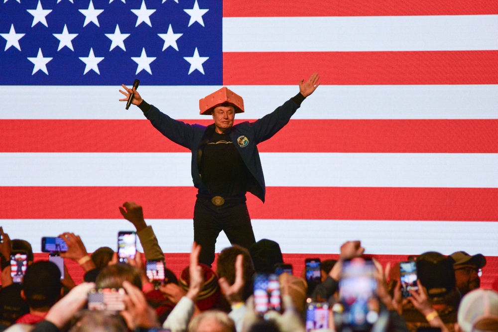 Musk, seen here wearing a cheese-themed hat in Green Bay, Wisconsin, described two of the recipients of his checks as spokespeople for America PAC (AFP/Getty)