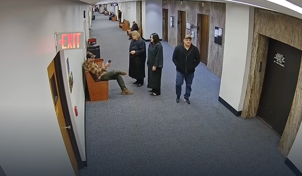 Judge Hanna Dugan is seen speaking with plain-clothes federal agents in a Milwaukee County courthouse on April 18 (Milwaukee County Sheriff's Office)