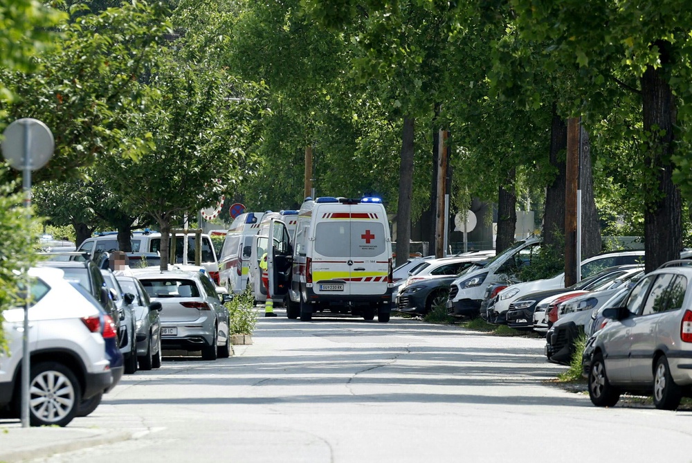 Ambulance cars are seen in a street close to a school where, according to reports, several people died in a shooting (APA/AFP via Getty Images)