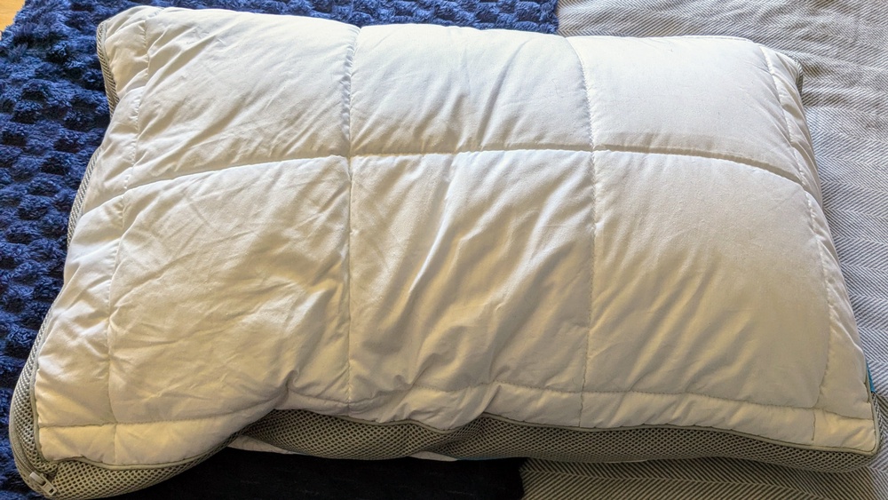 The construction feels thoughtfully engineered, with a smooth cotton surface on one side and the cooling layer on the other (Caroline Preece/The Independent)