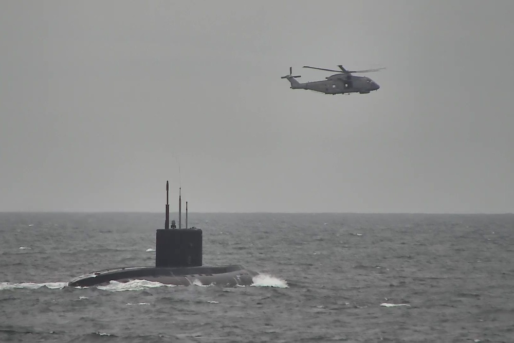 Royal Navy helicopters and a warship shadow a surfaced Russian submarine as it sails through the North Sea and English Channel (PA Media)