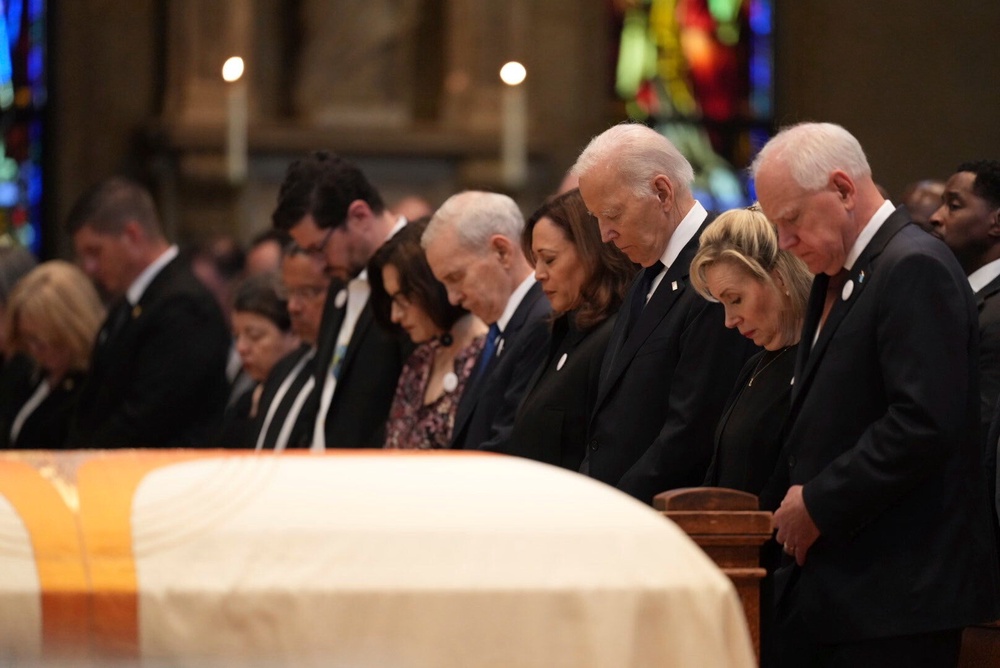 From left, Minnesota attorney general Keith Ellison, Tom Weber, Lt. Gov. Peggy Flanagan, former Minnesota Gov. Mark Dayton, former US Vice President Kamala Harris, former US President Joe Biden, Gwen Walz and Minnesota Gov. Tim Walz attend funeral services for Mark and Melissa Hortman at the Basilica of St. Mary in Minneapolis (Minnesota Star Tribune)