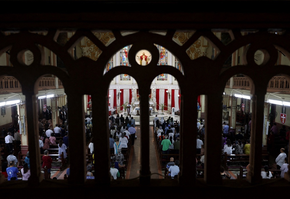 People attend a memorial held for the deceased crew members of the Air India Boeing 787-8 Dreamliner plane, which crashed during take-off from an airport in Ahmedabad, at a church in Mumbai, India (REUTERS)