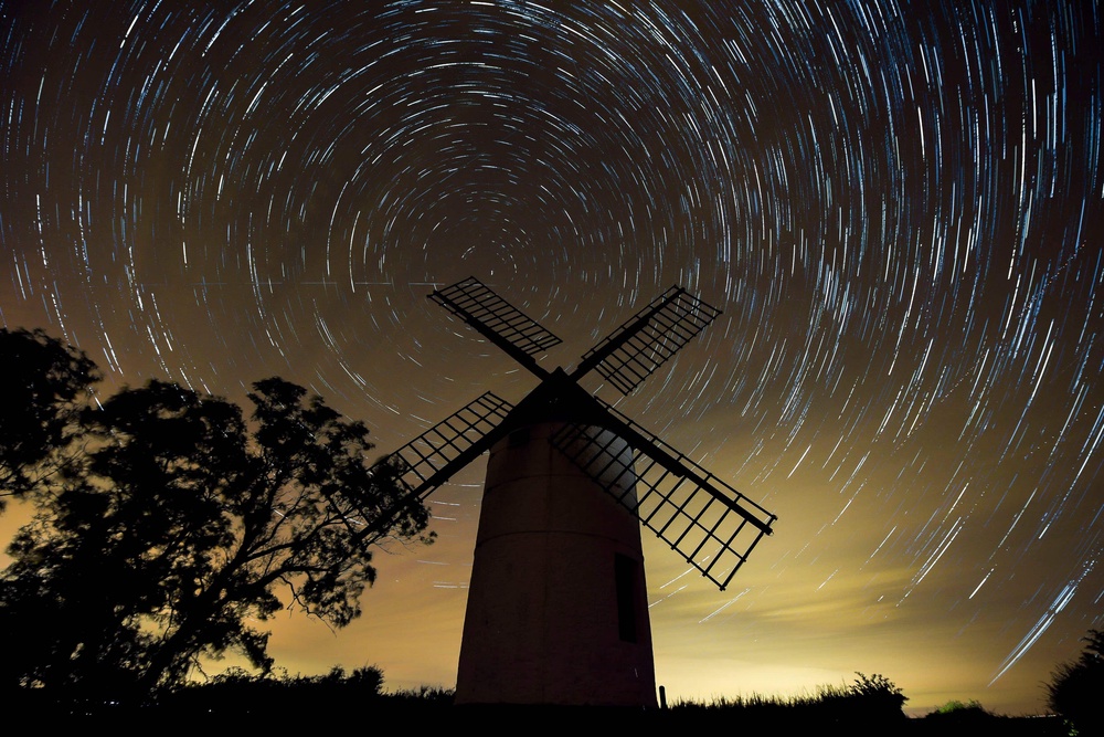 A composite image made from 726 photographs taken over three hours from midnight showing the rotation of the earth around Polaris, the North Star, in the night sky over Ashton Windmill, Somerset (Ben Birchall/PA) (PA Archive)