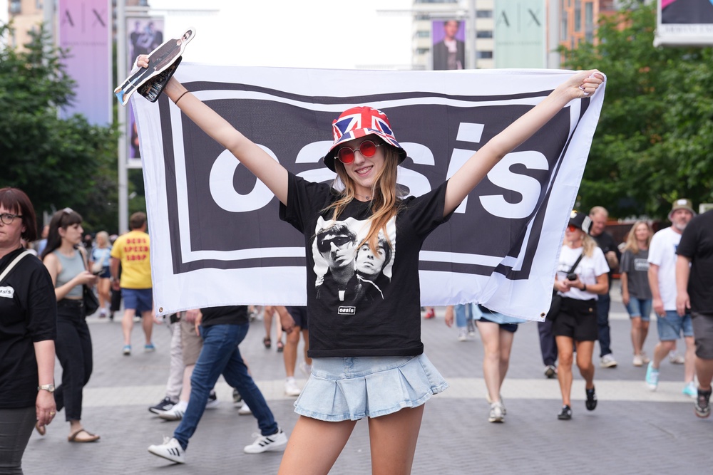 An Oasis fan attending the first night of the tour in London (PA Wire)