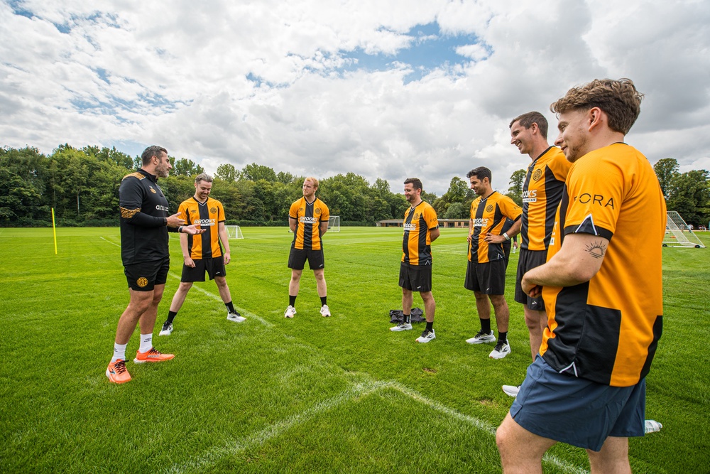 Cambridge United's executive performance lead Laurence Bloom taking journalists through a warm-up (Brooks Running)