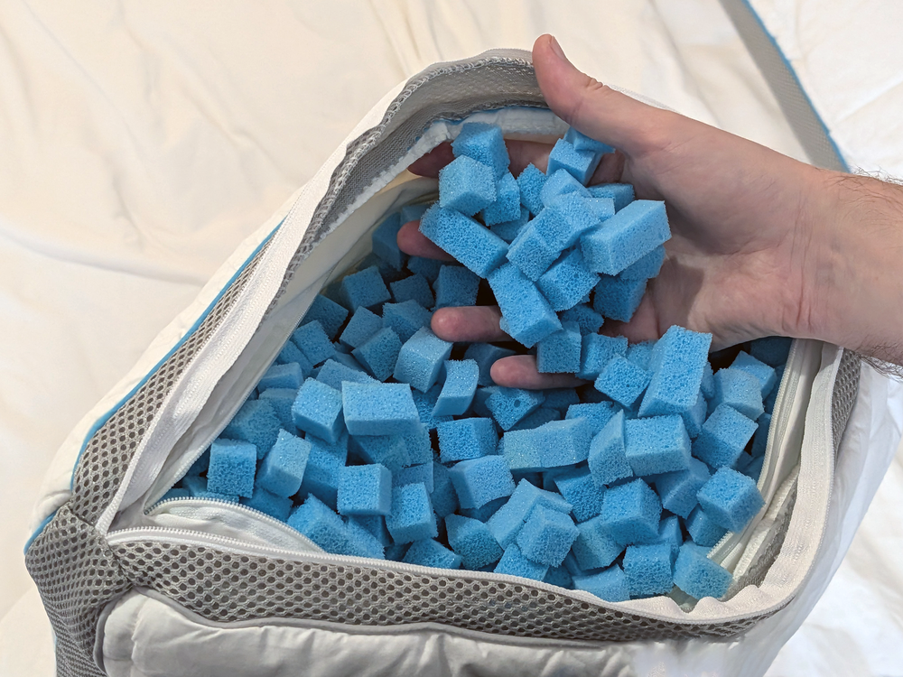 The pillow is packed with squishy foam nanocubes. You can remove some or add more to adjust head height, or mess them up one every few weeks to keep the pillow plump. (Liz Dodd/The Independent)