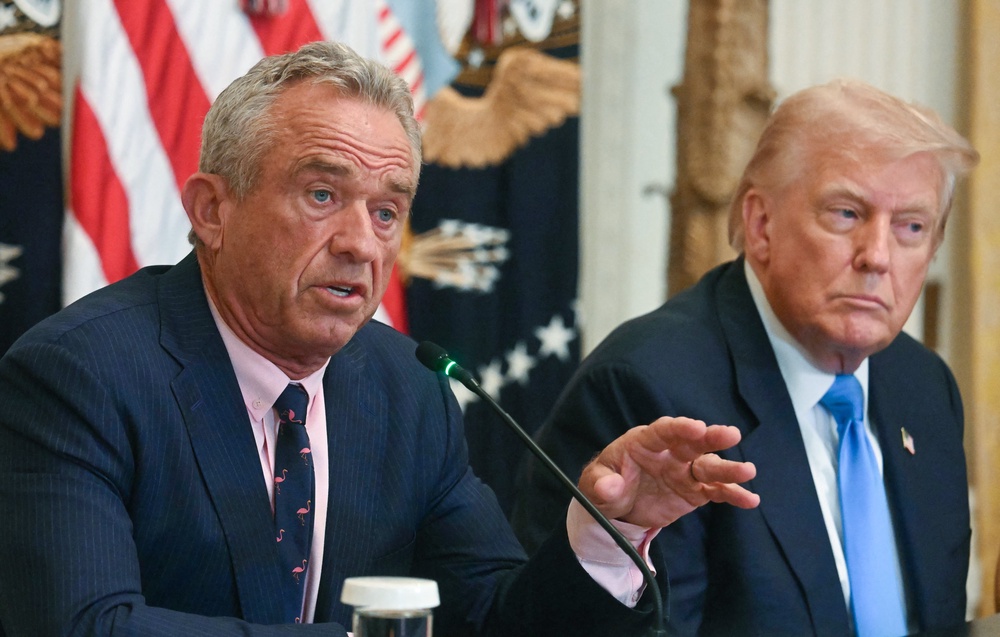 President Donald Trump listens as US Secretary of Health and Human Services Robert F. Kennedy Jr. speaks at an event on