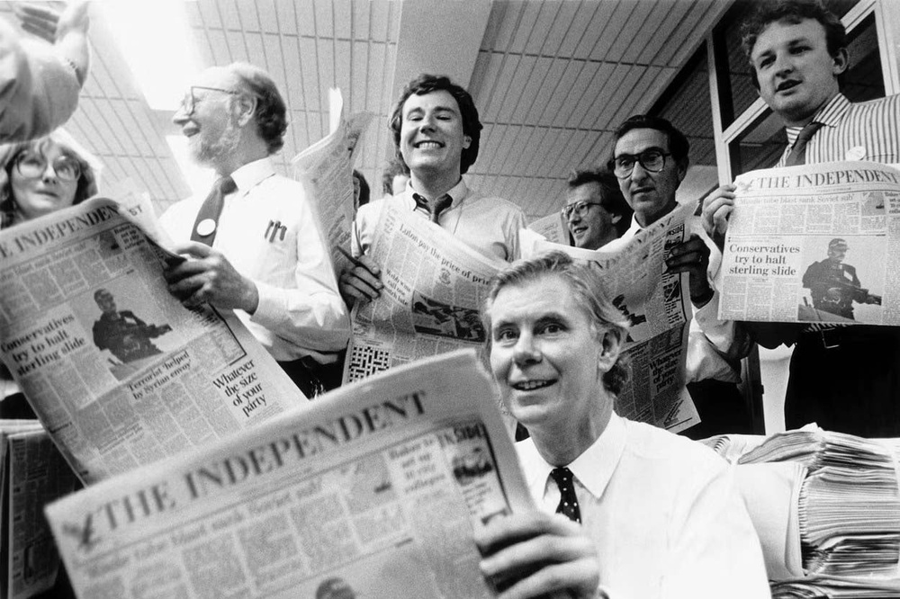 1986: Smith holding a copy of the first official Independent newspaper surrounded by editorial staff (The Independent)