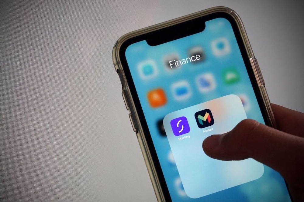 The icons for the Monzo and Starling Bank banking apps on a smartphone in Hartley Wintney, west of London on 19 August, 2020 (AFP via Getty Images)