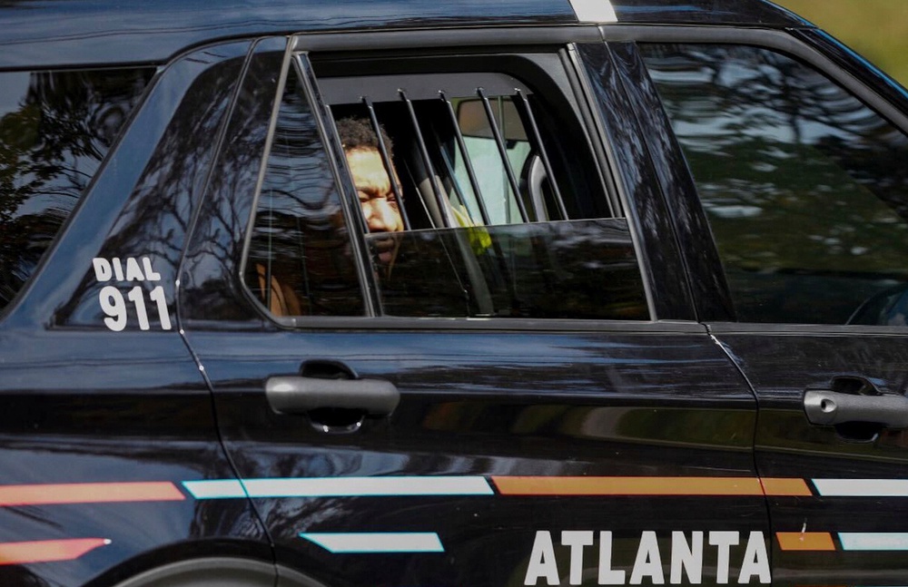 Escaped New Orleans inmate Derrick Groves looks out from a police vehicle after being arrested in Atlanta, Georgia, after five months on the run (Local Library)