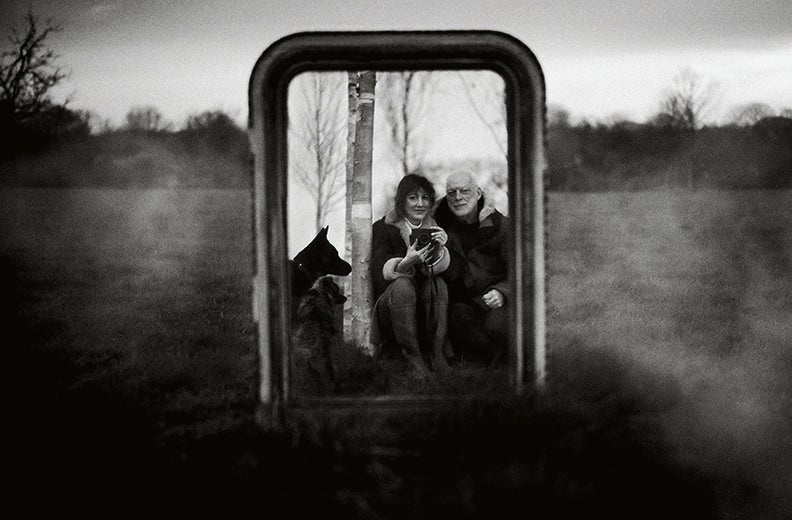 Samson, Gilmour and their dogs reflected in a large mirror (Photography by Polly Samson)