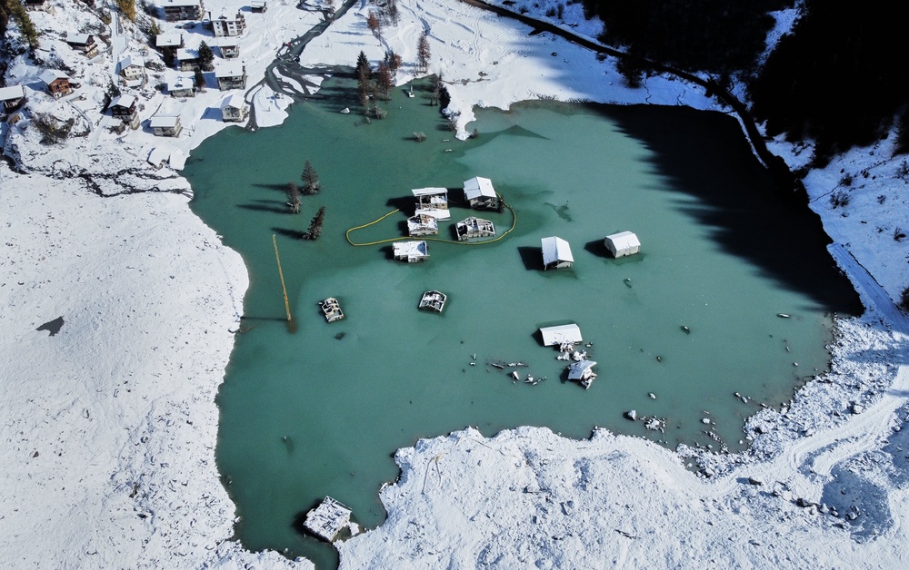 An aerial view shows the partly flooded village of Blatten after snowfalls, five months after a landslide destroyed the village, Blatten, Switzerland, on Tuesday, Oct. 28, 2025. (AP Photo/Michael Probst) (Copyright 2025 The Associated Press. All rights reserved)