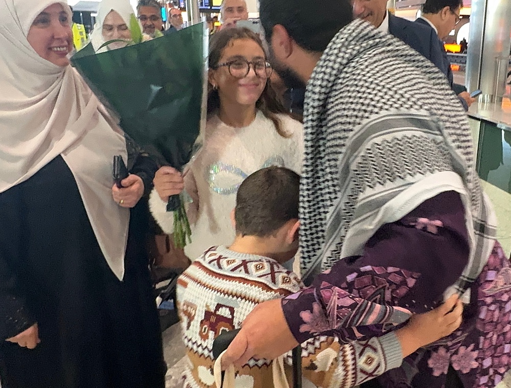 Hamdi being greeted by family members at Heathrow Airport upon his return to the UK (Free Sami Hamdi campaign)