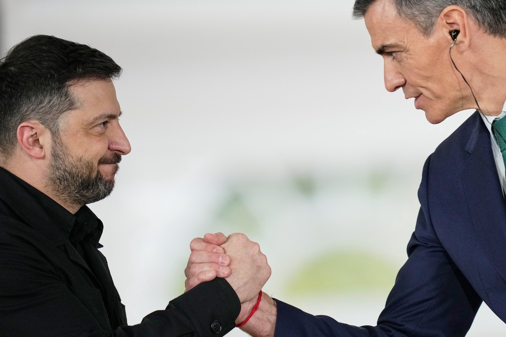 Sanchez, right, showing his support for Ukrainian president Volodymyr Zelensky (AP)
