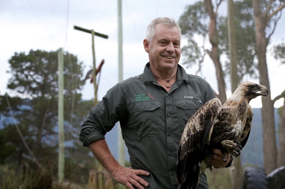 Craig Webb holding a bird at the Raptor and Wildlife Refuge of Tasmania Inc (PA)