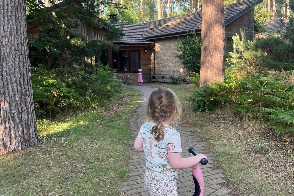 Enjoying some time on scooters outside the three-bed Forest Lodge (Becca Drake)