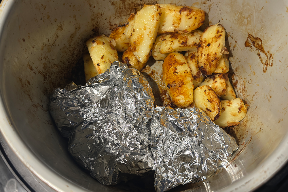 You can wrap carrots in tin foil and add them as the potatoes are finishing cooking (Rachael Penn/The Independent)
