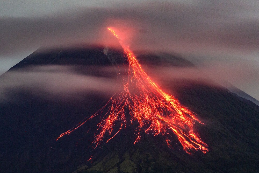 Indonesia has 120 active volcanoes, including Mount Merapi – seen here with lava spewing on to its slopes on 20 December 2025 (AFP/Getty)