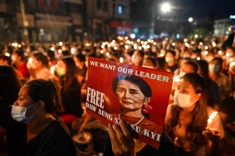 A protester holds an image of Aung San Suu Kyi during a demonstration against the military coup in Yangon on 13 March 2021 (AFP via Getty)