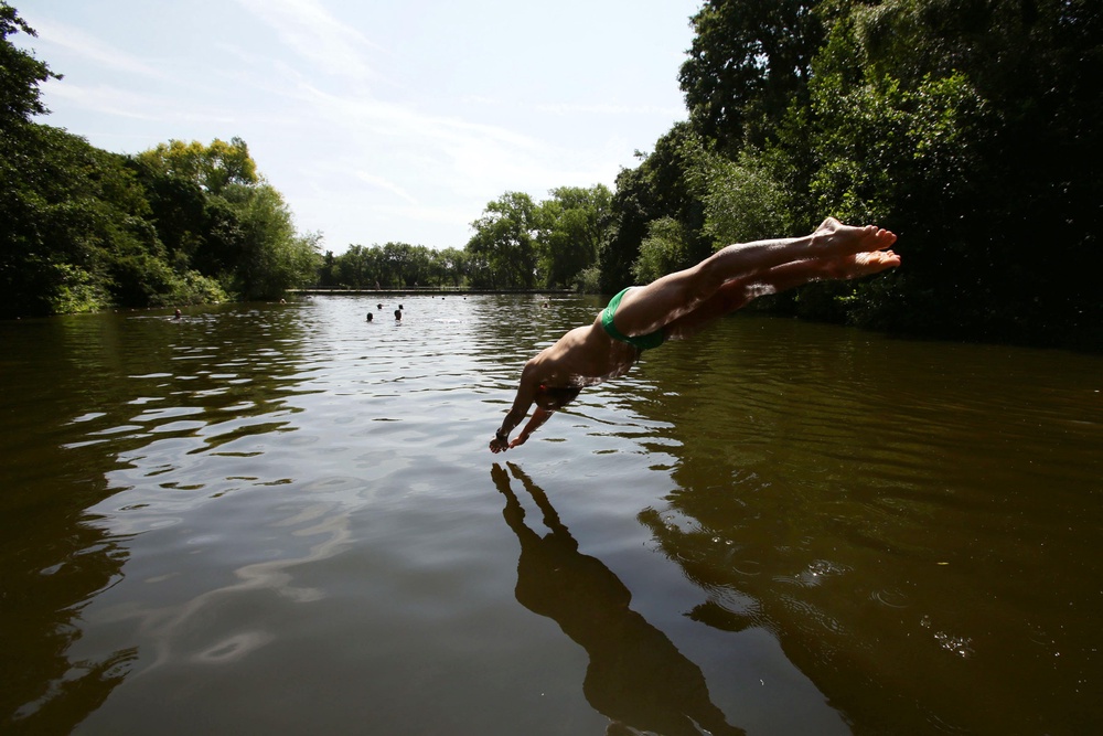 A man dives into Hampstead Heath bathing pond (PA Archive)