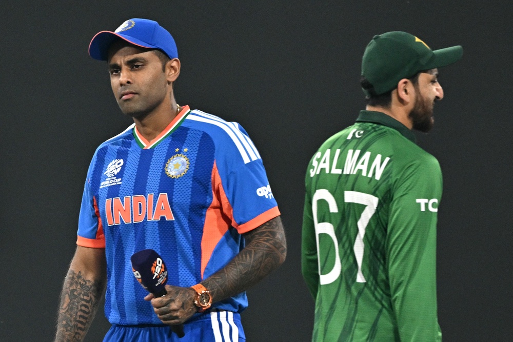 Indian captain Suryakumar Yadav walks past his Pakistani counterpart Salman Agha after the toss at the T20 Cricket World Cup group stage match in Colombo on 15 February 2026 (AFP via Getty)