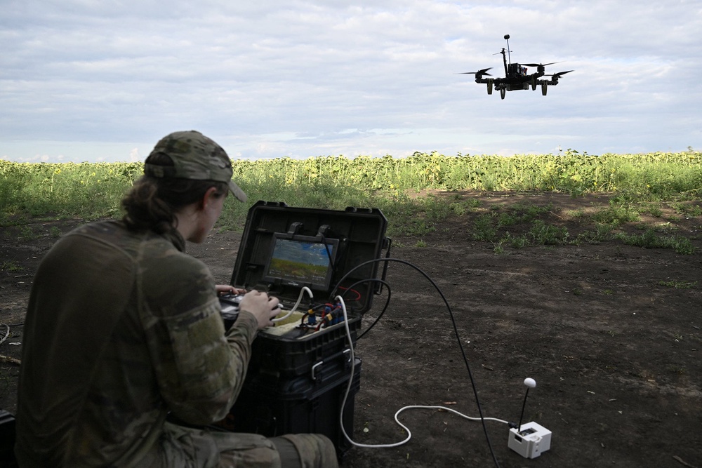 A drone pilot with the Ukrainian 3rd Army Corps controls an FPV drone during a training flight in an undisclosed location, in August 2025 (AFP/Getty)