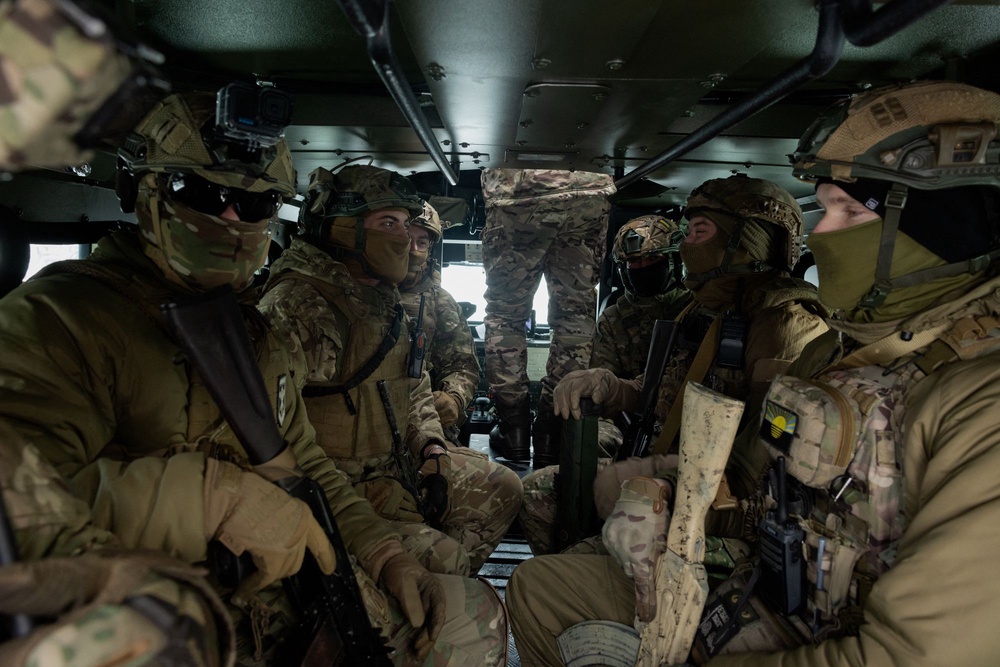 Ukrainian servicemen of the 18th Sloviansk Brigade of the National Guard of Ukraine sit in military vehicles during a training at an undisclosed location in Donetsk region (AFP/Getty)