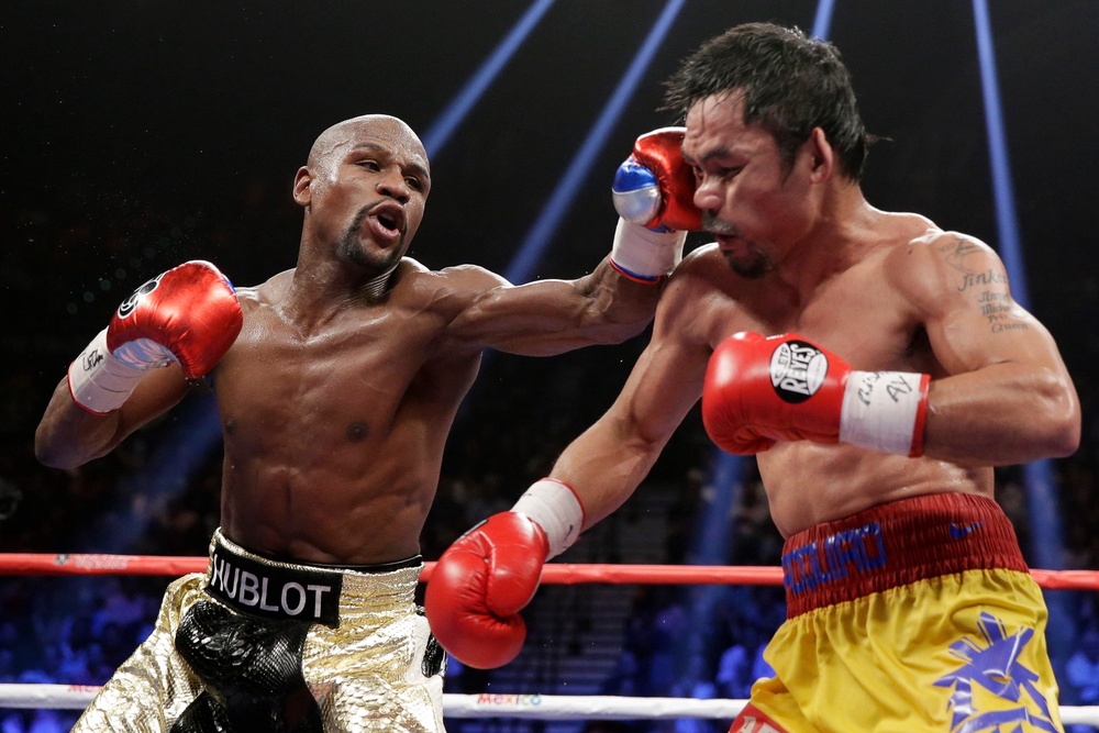 Mayweather, Jr. of the U.S. lands a left to the face of Pacquiao of the Philippines in the 11th round during their welterweight title fight in Las Vegas (AP)