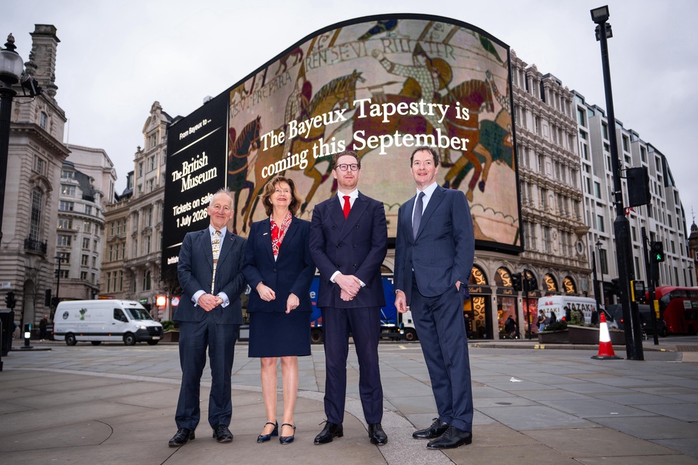 (left to right) Lord Peter Ricketts, French ambassador Helene Duchene, Nicholas Cullinan and George Osborne stand in front of the Piccadilly Circus advertising board announcing the date that tickets to the Bayeux Tapestry exhibition will go on sale (PA)